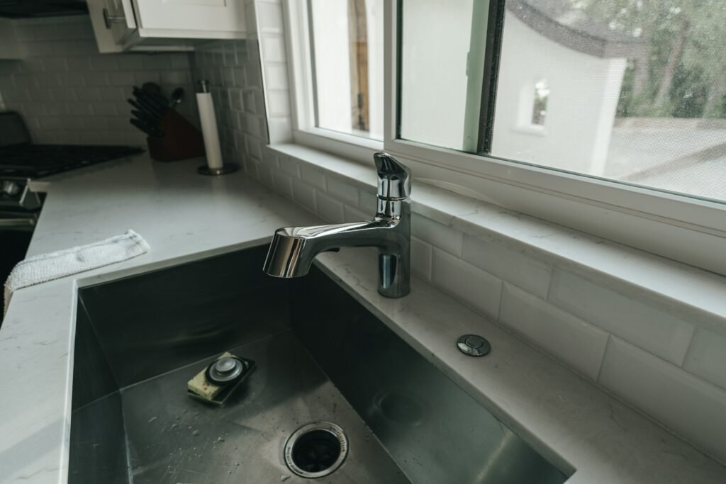 Kitchen sink with a faucet