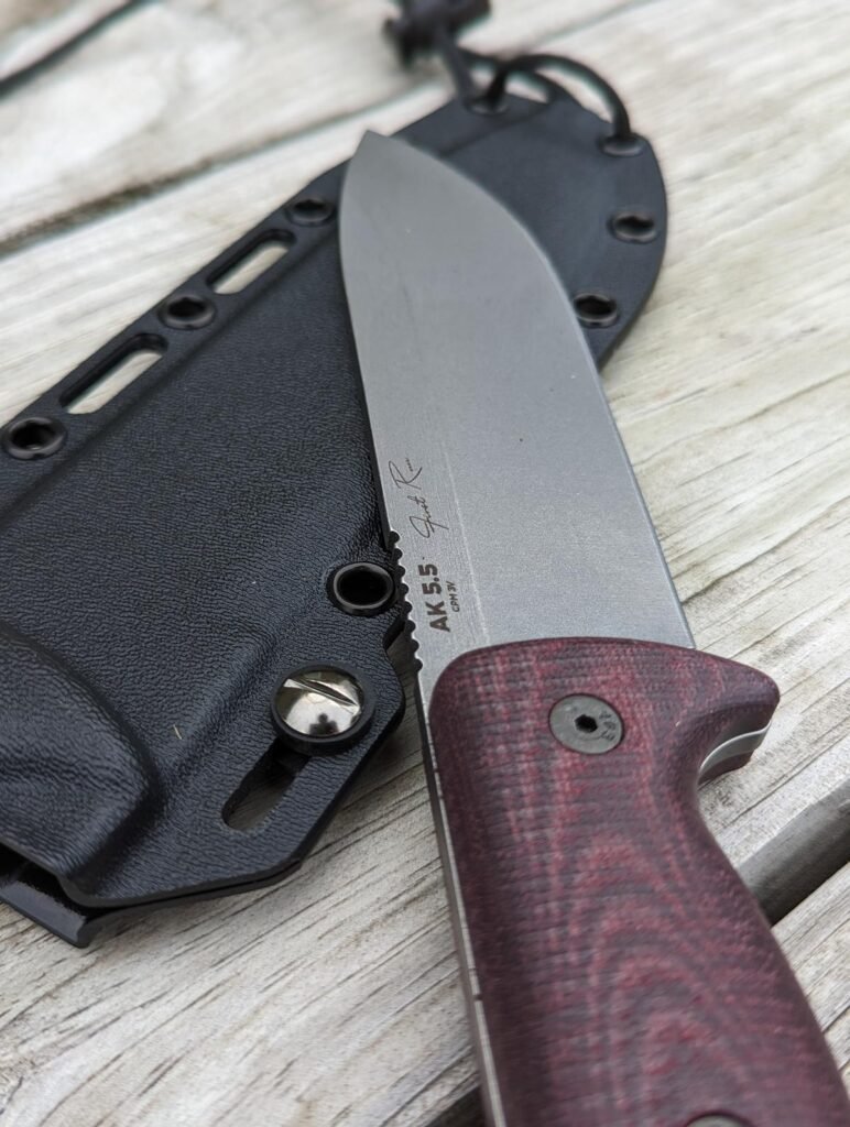 Knife blade resting on top of a sheath