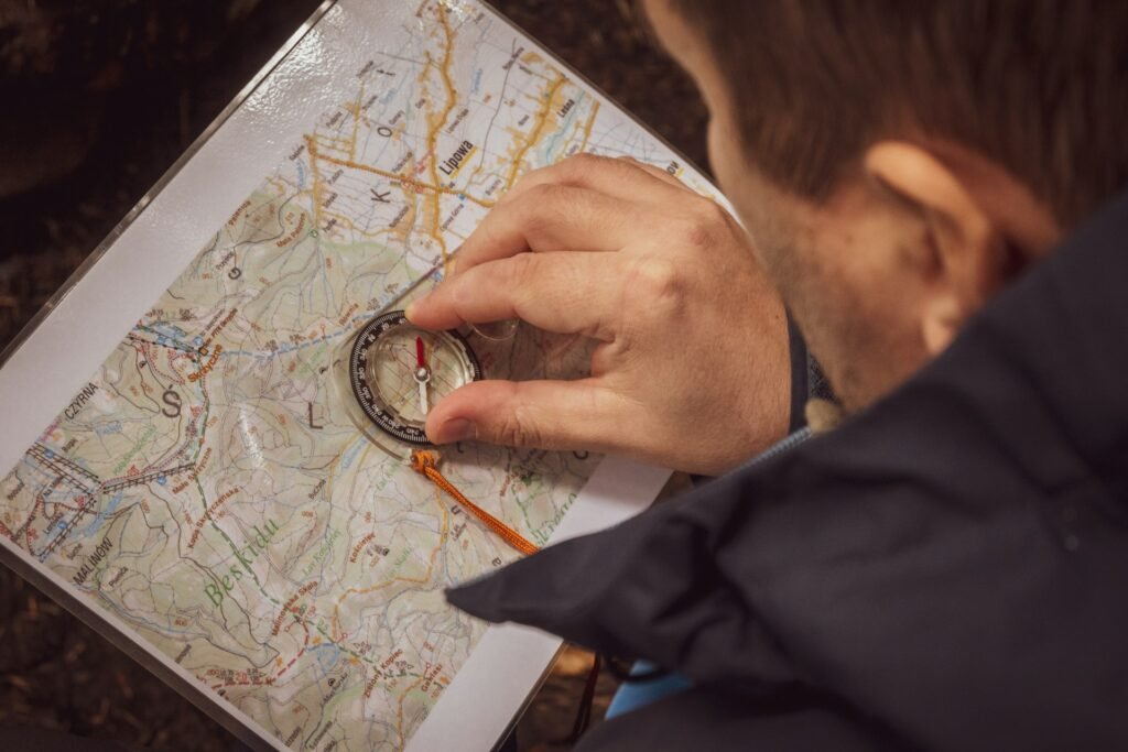 Man navigating with a map and compass